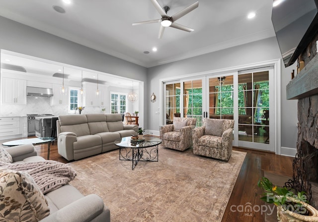 12835 Ninebark Trl, Charlotte, NC 28278 - living room featuring a ceiling fan, dark wood-type flooring, ornamental molding, recessed lighting, and baseboards