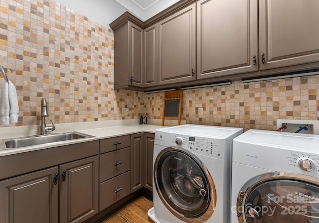 12835 Ninebark Trl, Charlotte, NC 28278 - laundry area featuring washer and clothes dryer, cabinet space, and light wood-type flooring