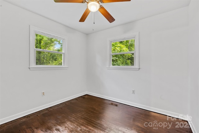 unfurnished room featuring baseboards, ceiling fan, wood-type flooring, and visible vents