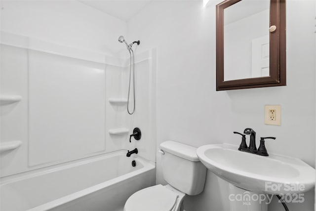 bathroom featuring toilet, shower / bathtub combination, and a sink