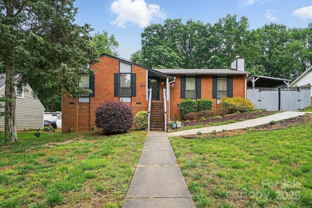6221 Thermal Rd, Charlotte, NC 28211 - view of front of home with brick siding, a chimney, and a carport