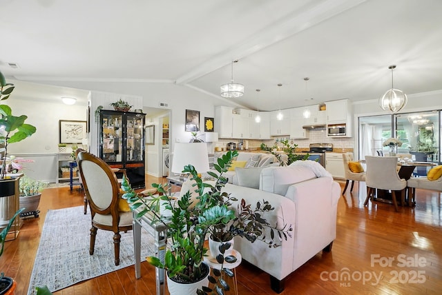 6221 Thermal Rd, Charlotte, NC 28211 - living room with wood finished floors, ornamental molding, a chandelier, and washer / dryer