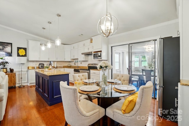 6221 Thermal Rd, Charlotte, NC 28211 - dining area featuring a chandelier, dark wood-type flooring, and ornamental molding