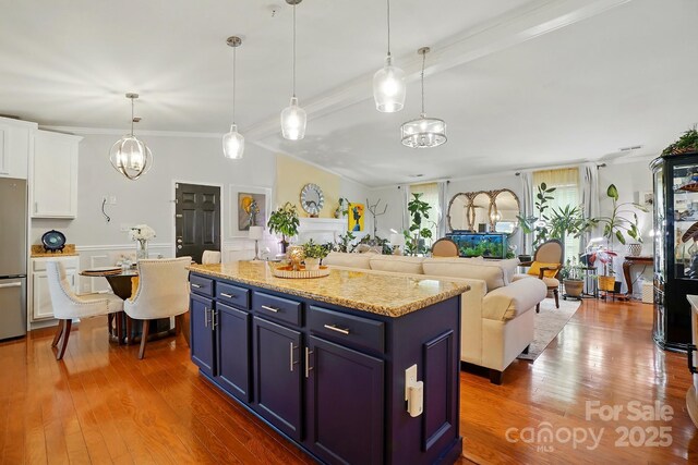 6221 Thermal Rd, Charlotte, NC 28211 - kitchen featuring freestanding refrigerator, blue cabinets, white cabinetry, ornamental molding, and wood finished floors