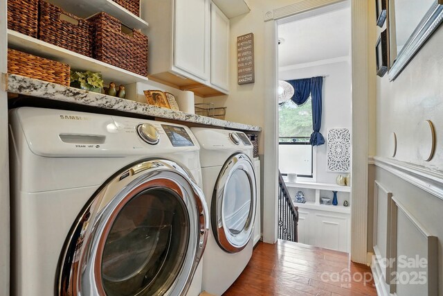 6221 Thermal Rd, Charlotte, NC 28211 - laundry room featuring cabinet space, ornamental molding, wood finished floors, and washer and clothes dryer