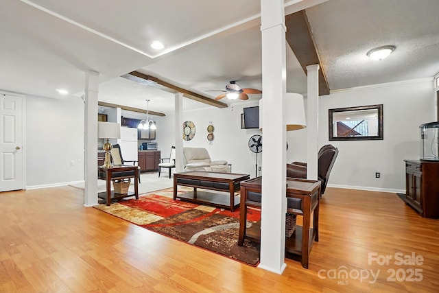 6221 Thermal Rd, Charlotte, NC 28211 - living area with light wood-style flooring, ceiling fan, baseboards, and decorative columns