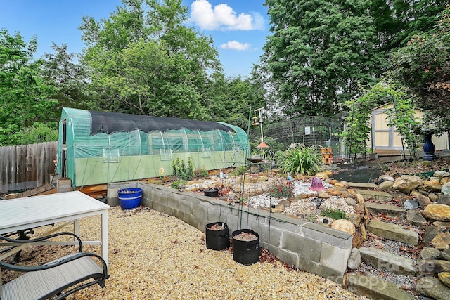6221 Thermal Rd, Charlotte, NC 28211 - view of yard featuring an exterior structure, an outdoor structure, fence, and a garden