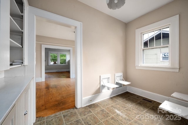 bathroom with baseboards and visible vents