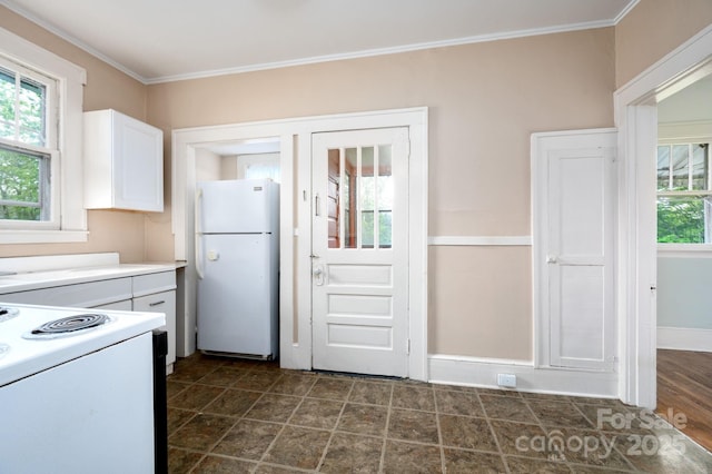 kitchen featuring baseboards, white appliances, crown molding, light countertops, and white cabinets