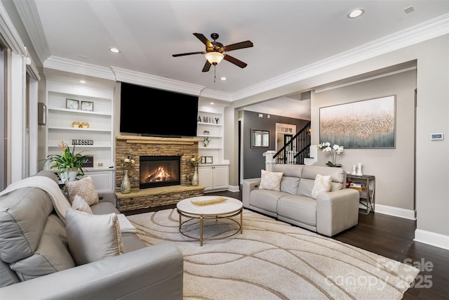 16109 Reynolds Dr, Indian Land, SC 29707 - living area with baseboards, a ceiling fan, crown molding, stairway, and a stone fireplace