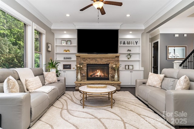 16109 Reynolds Dr, Indian Land, SC 29707 - living area with ceiling fan, a stone fireplace, ornamental molding, built in shelves, and recessed lighting