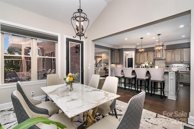 16109 Reynolds Dr, Indian Land, SC 29707 - dining area with a chandelier, lofted ceiling, dark wood-style flooring, recessed lighting, and ornamental molding