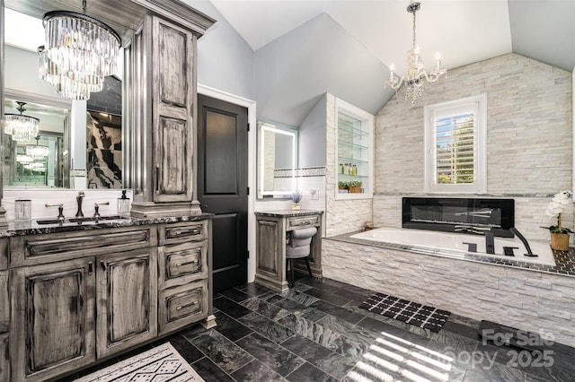 16109 Reynolds Dr, Indian Land, SC 29707 - bathroom with a chandelier, vaulted ceiling, vanity, and a bath