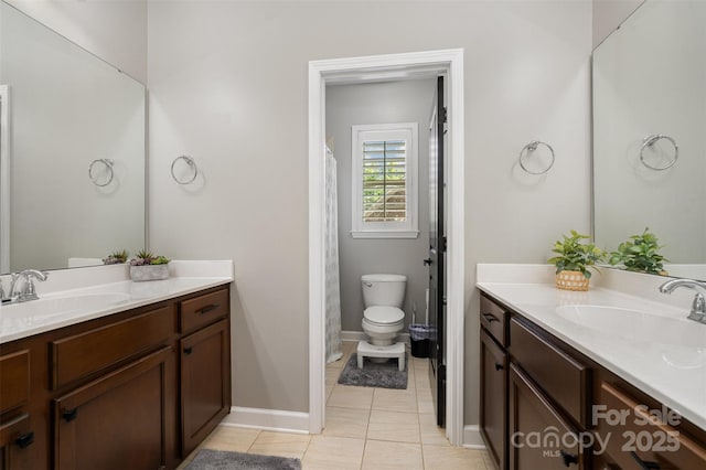 16109 Reynolds Dr, Indian Land, SC 29707 - bathroom featuring two vanities, tile patterned floors, toilet, and baseboards