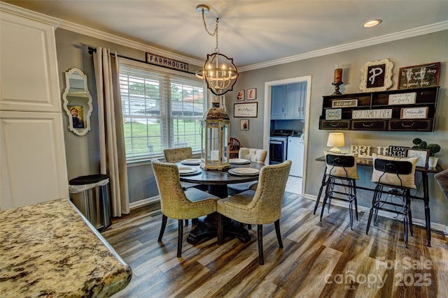 800 Sunset Rd, Cherryville, NC 28021 - dining area featuring washing machine and clothes dryer, a chandelier, dark wood-type flooring, crown molding, and baseboards