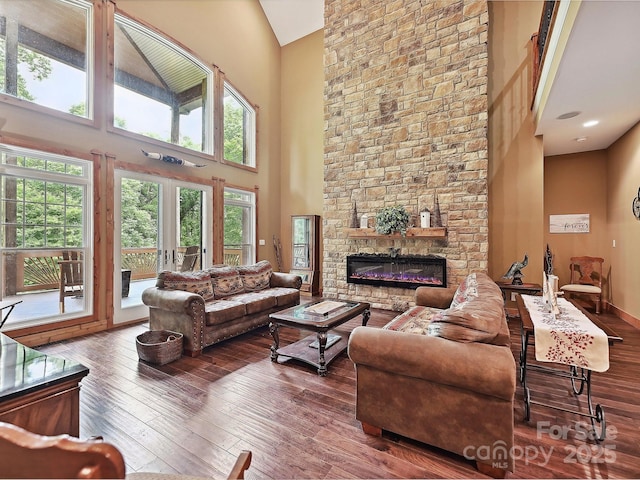 1140 Fern Hill Rd, Mooresville, NC 28117 - living room with high vaulted ceiling, plenty of natural light, hardwood / wood-style floors, and a fireplace