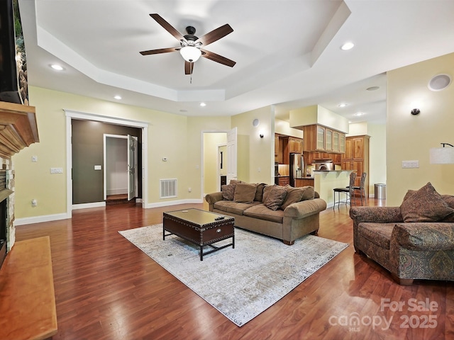 1140 Fern Hill Rd, Mooresville, NC 28117 - living area featuring ceiling fan, a raised ceiling, dark wood-type flooring, recessed lighting, and a fireplace