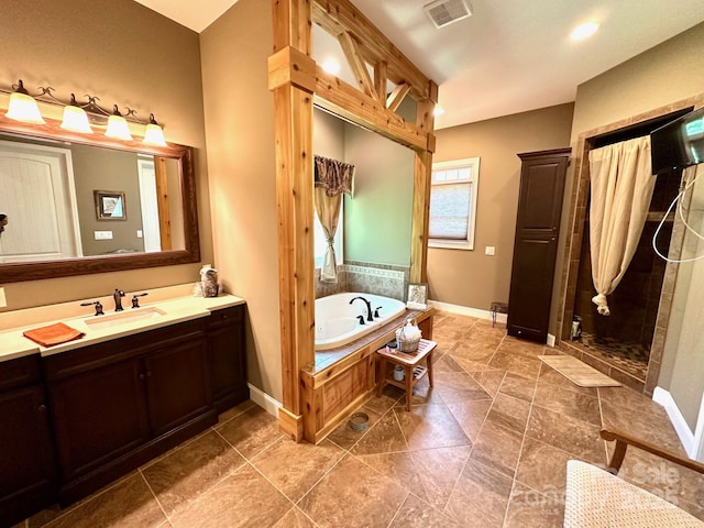 1140 Fern Hill Rd, Mooresville, NC 28117 - bathroom with a garden tub, vanity, baseboards, and walk in shower