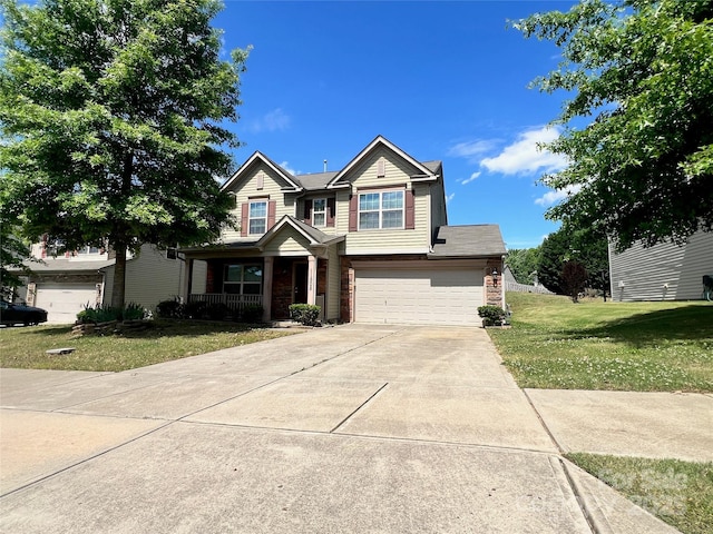 craftsman house featuring a porch, driveway, a garage, and a front yard