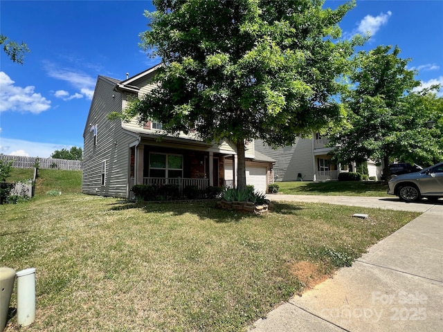 view of property hidden behind natural elements with a porch and a front yard