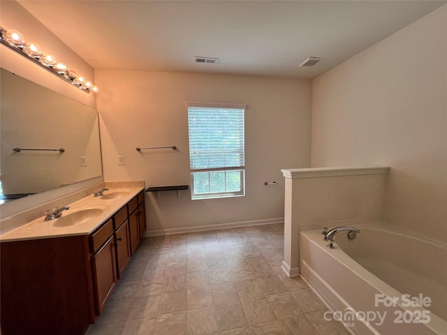 full bath featuring double vanity, a garden tub, visible vents, and a sink
