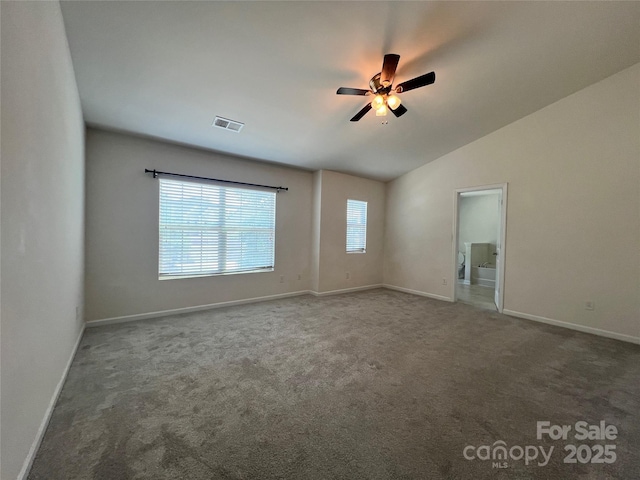 carpeted spare room with baseboards, visible vents, a ceiling fan, and vaulted ceiling