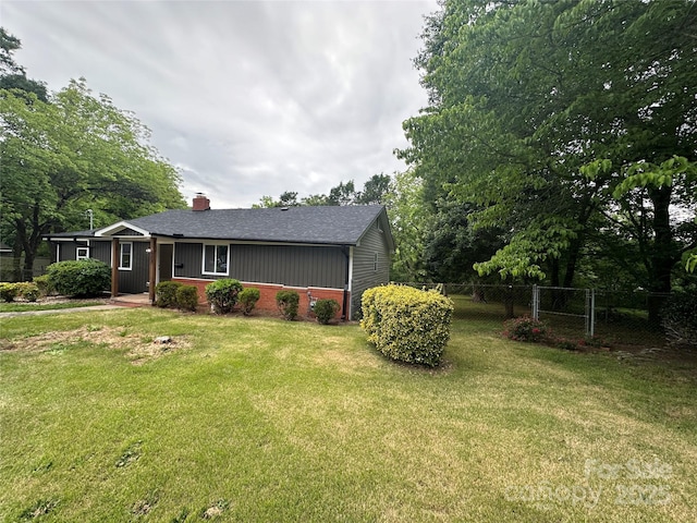view of front of home featuring a chimney, a shingled roof, and brick siding