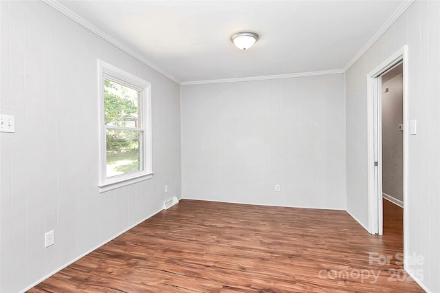unfurnished room featuring wood finished floors and ornamental molding