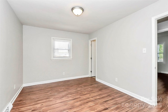 unfurnished room featuring wood finished floors and baseboards