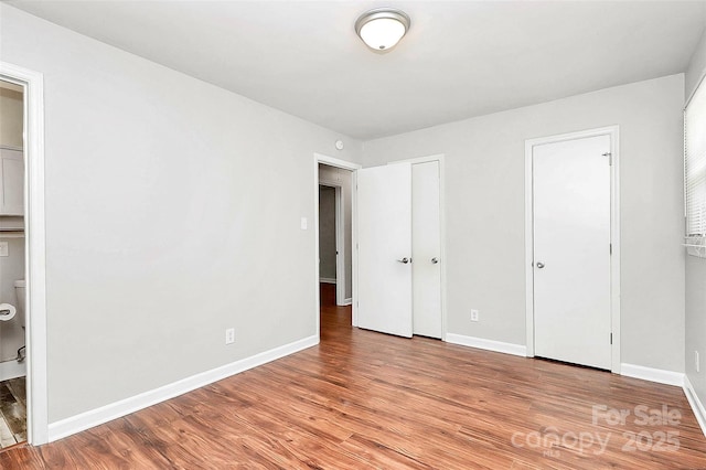 unfurnished bedroom with light wood finished floors and baseboards