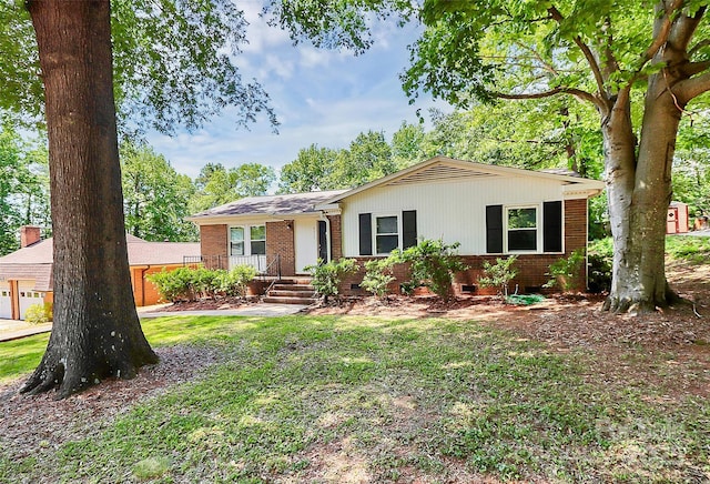 single story home with a garage, brick siding, and a front yard