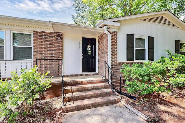 entrance to property with brick siding