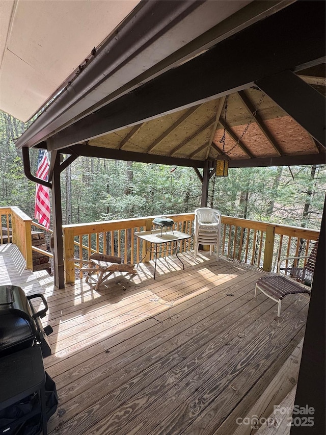 wooden deck featuring a grill and a gazebo