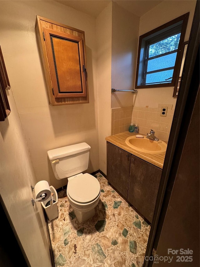 bathroom with toilet and vanity