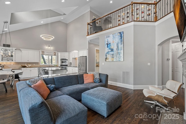18823 Peninsula Cove Ln, Cornelius, NC 28031 - living room featuring a towering ceiling, baseboards, recessed lighting, dark wood-type flooring, and a chandelier