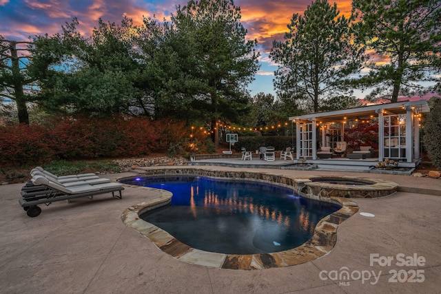 18823 Peninsula Cove Ln, Cornelius, NC 28031 - pool at dusk with a patio area, a pool with connected hot tub, and an outdoor structure