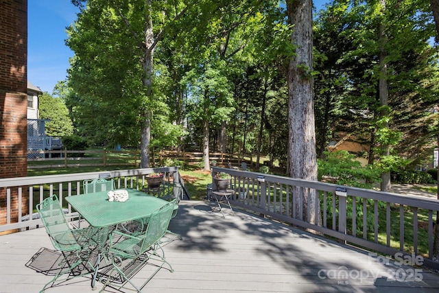 wooden deck featuring outdoor dining area