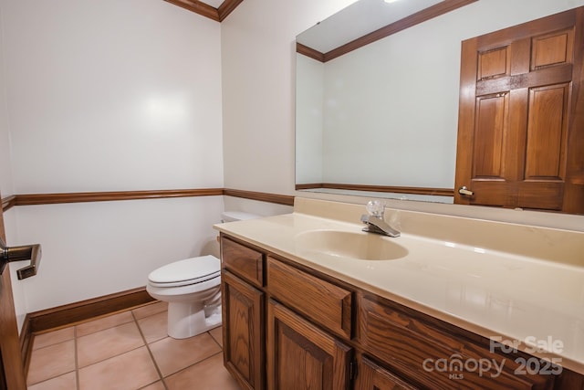 bathroom featuring crown molding, toilet, vanity, and tile patterned floors