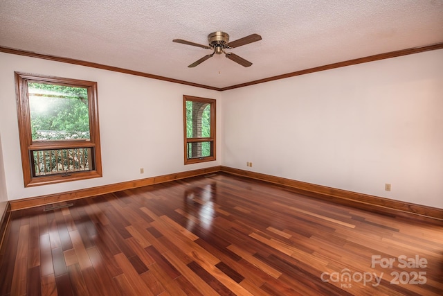 empty room featuring dark wood-style flooring, baseboards, ceiling fan, a textured ceiling, and ornamental molding