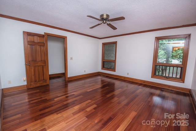 spare room featuring wood finished floors, a ceiling fan, a textured ceiling, baseboards, and crown molding
