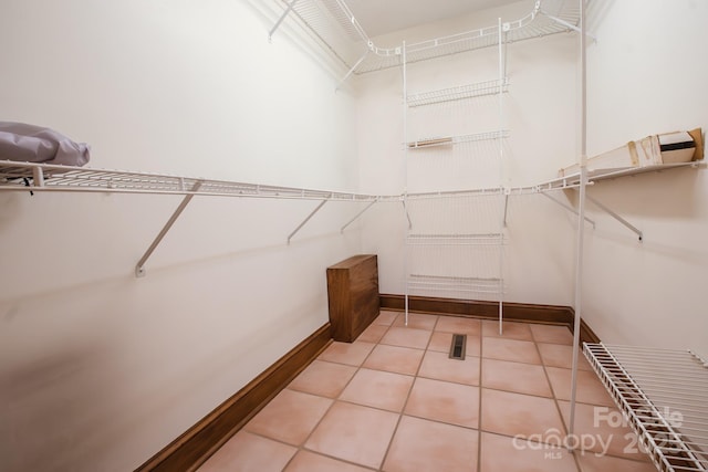 walk in closet with tile patterned floors