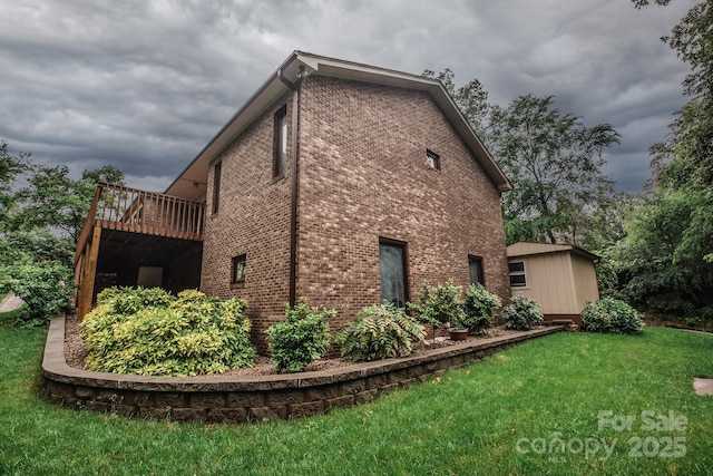 view of side of property featuring brick siding and a yard