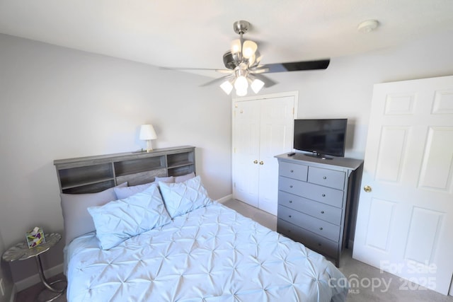 bedroom featuring ceiling fan, a closet, and baseboards