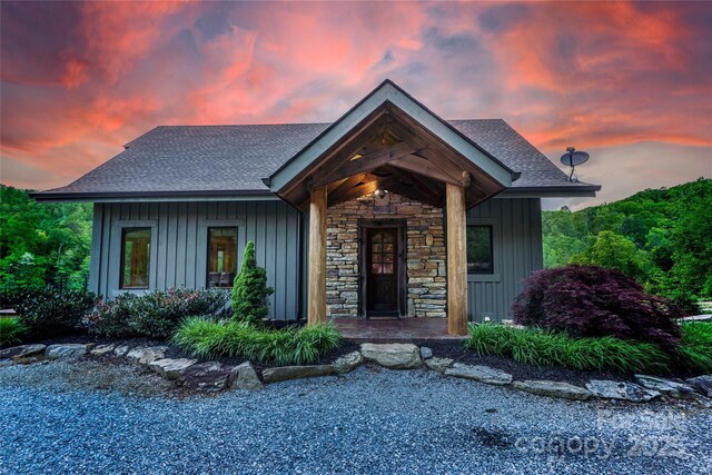 55 Maynards Way, Hendersonville, NC 28792 - view of front facade featuring stone siding, board and batten siding, and roof with shingles