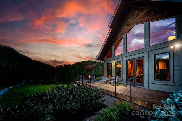 55 Maynards Way, Hendersonville, NC 28792 - back of property at dusk featuring a wooden deck and a yard