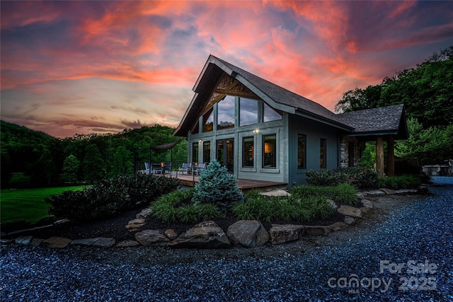 55 Maynards Way, Hendersonville, NC 28792 - back of property at dusk featuring a deck and a shingled roof