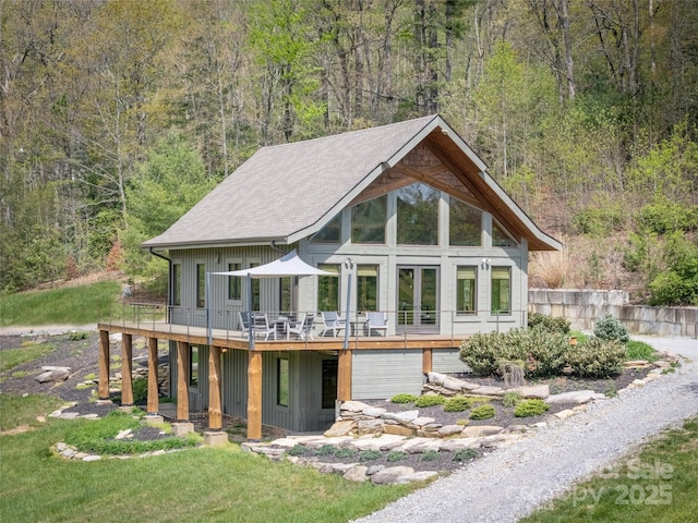 55 Maynards Way, Hendersonville, NC 28792 - rear view of house featuring a wooden deck, a wooded view, a shingled roof, and a yard