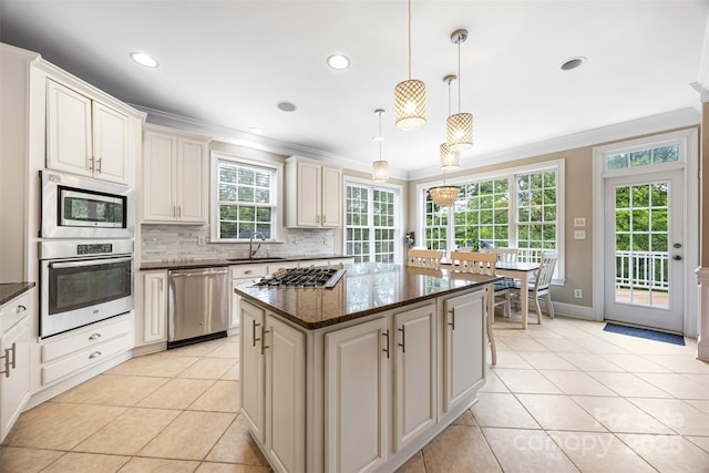 10452 Quiet Bay Ct, Charlotte, NC 28278 - kitchen featuring appliances with stainless steel finishes, crown molding, a sink, light tile patterned flooring, and tasteful backsplash