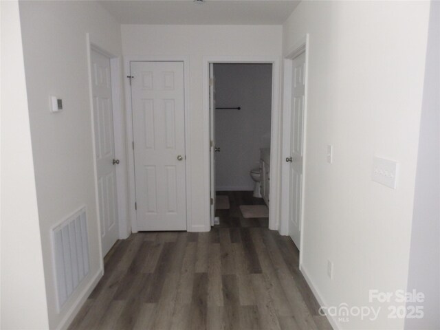 hall with wood finished floors and baseboards