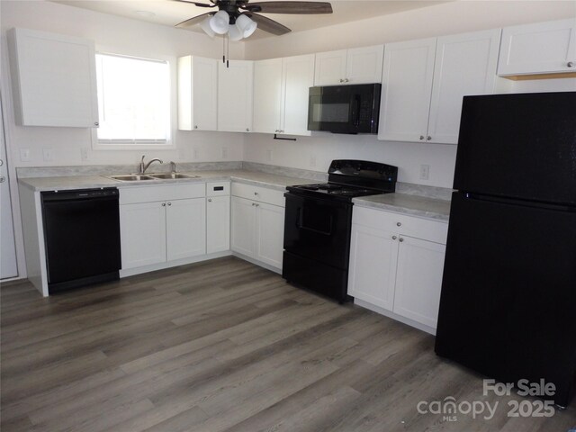 kitchen featuring black appliances, a sink, a ceiling fan, and white cabinets